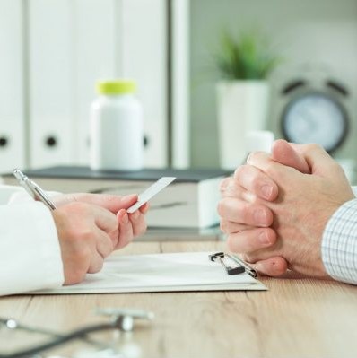 Doctor taking medical insurance card from patient - 398x399