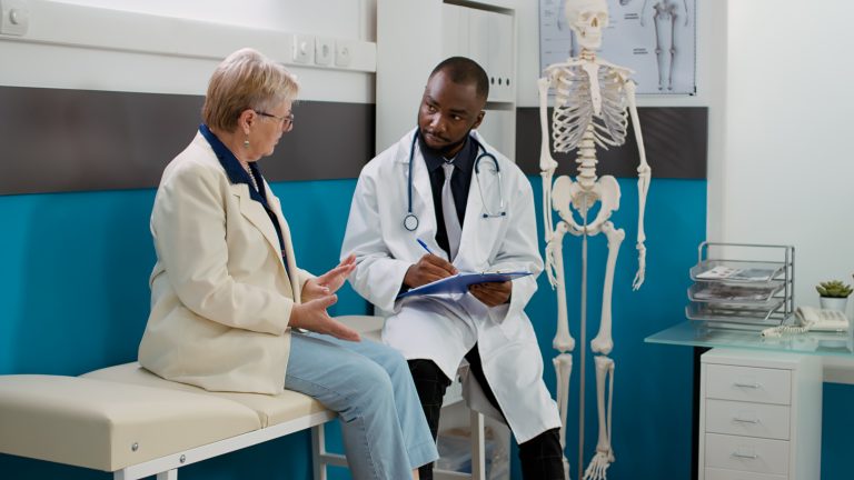 Physician doing medicare consultation with senior patient